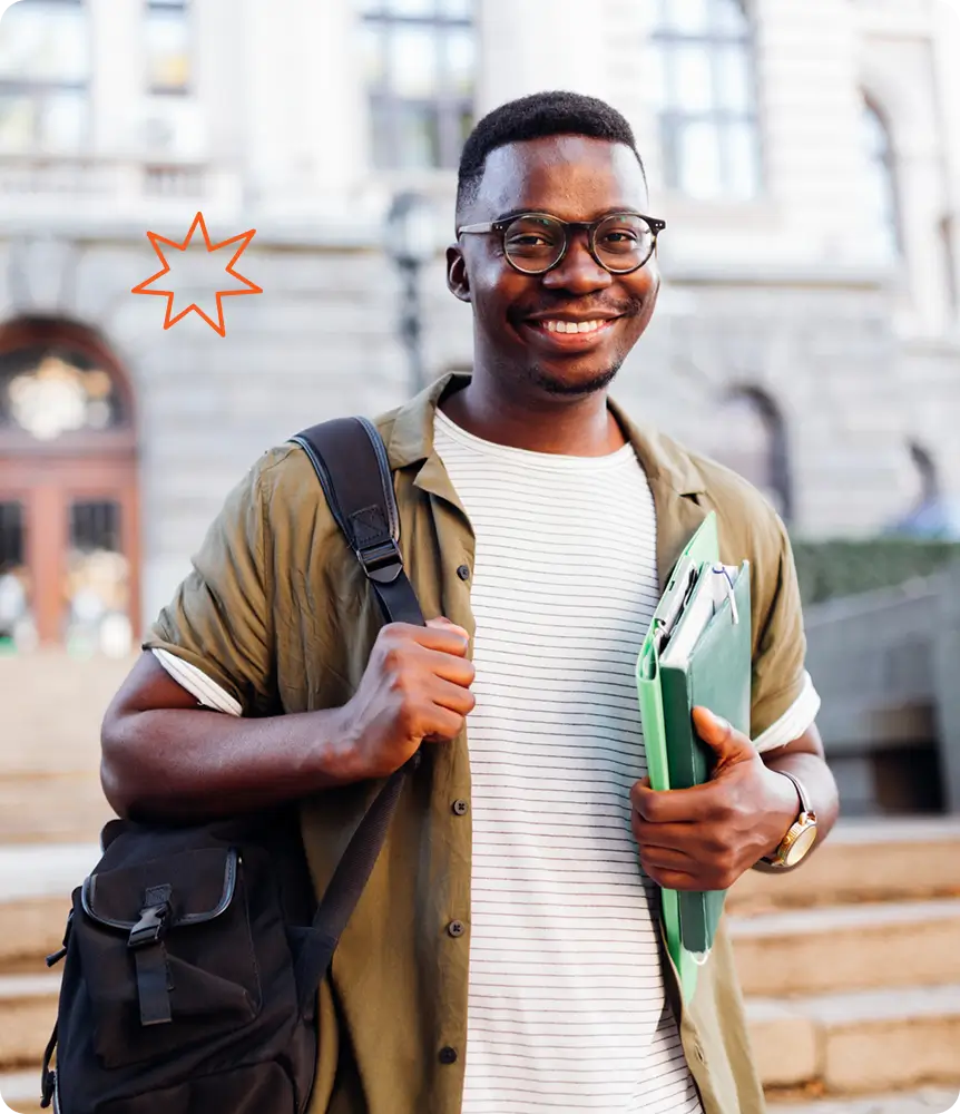 student with glasses holding books