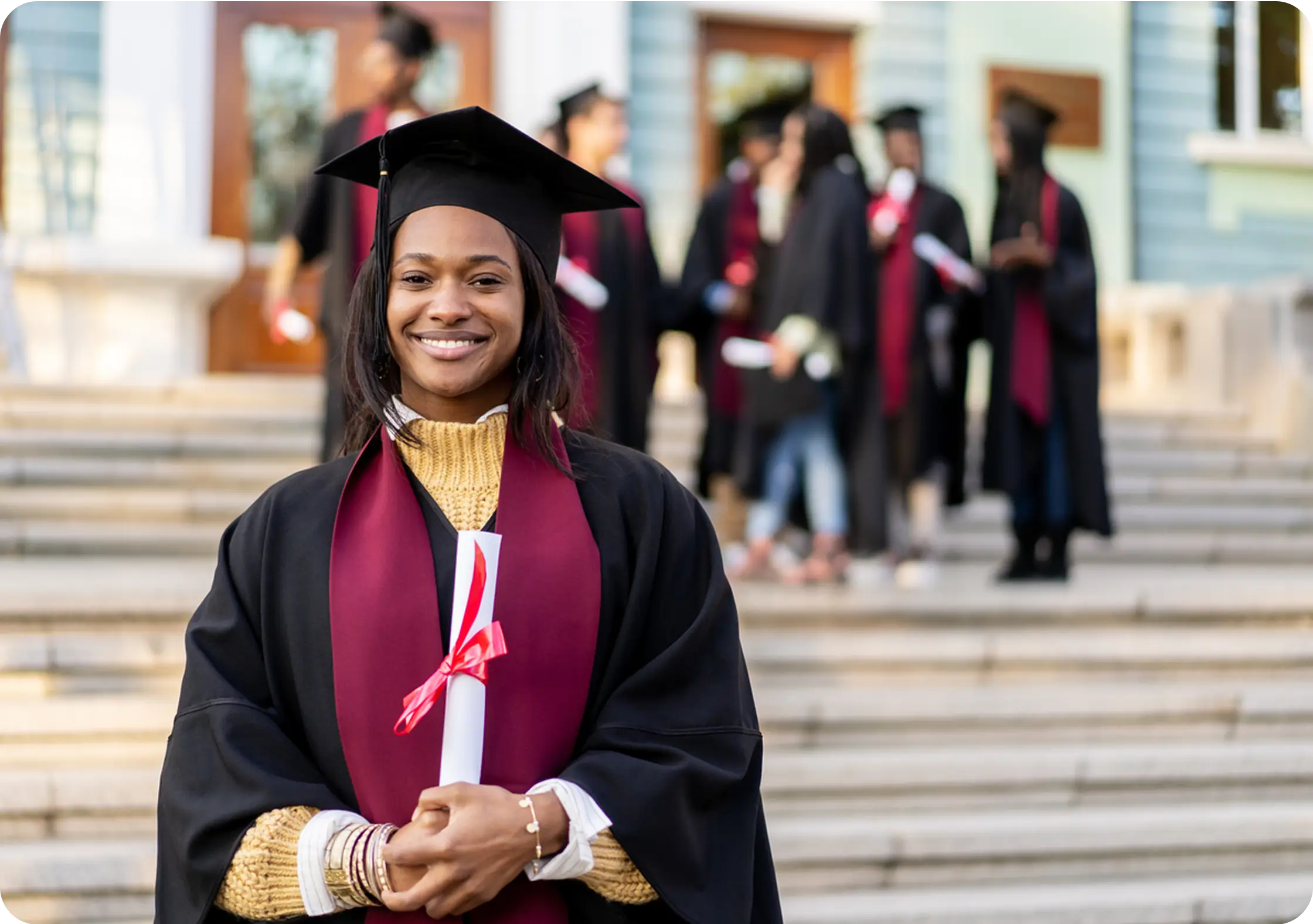 female student holding diploma university