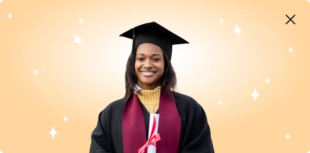 A smiling young black woman in a black graduation gown and cap holding a diploma tied with a red ribbon