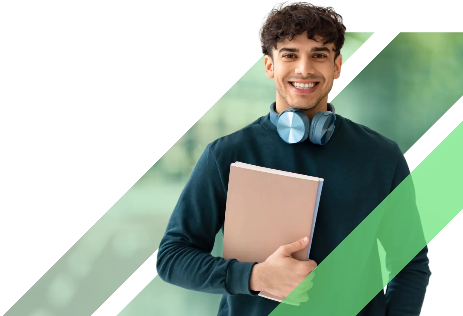 A smiling young male student with curly hair holding a notebook and wearing blue headphones around his neck.