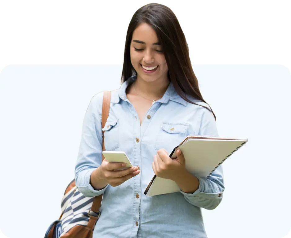student holding notepad and looking at phone