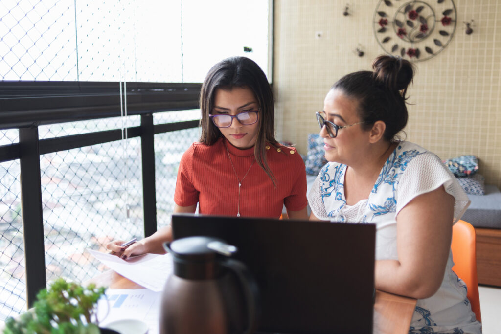 Mother and daughter doing finances together at home