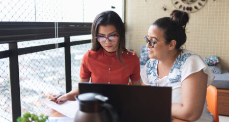 Mother and daughter doing finances together at home