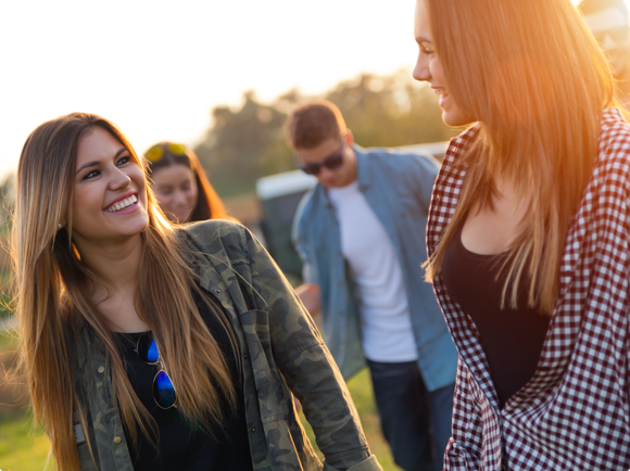 Two woman staring at each other and a woman and a man in the background