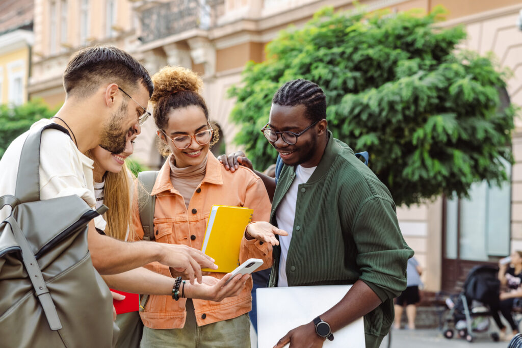 Group of college students looking at smart phone