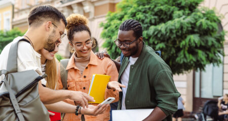 Group of college students looking at smart phone