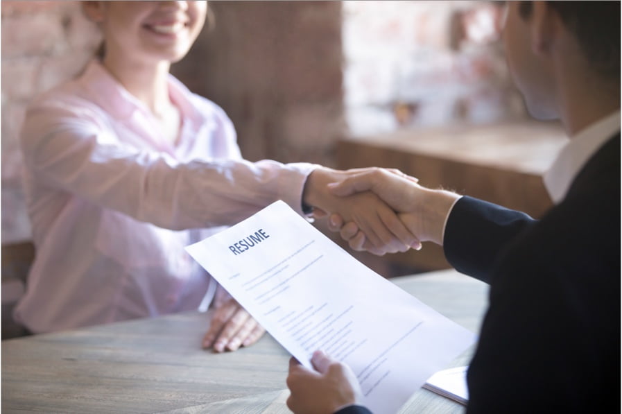 A woman and a man shaking hands