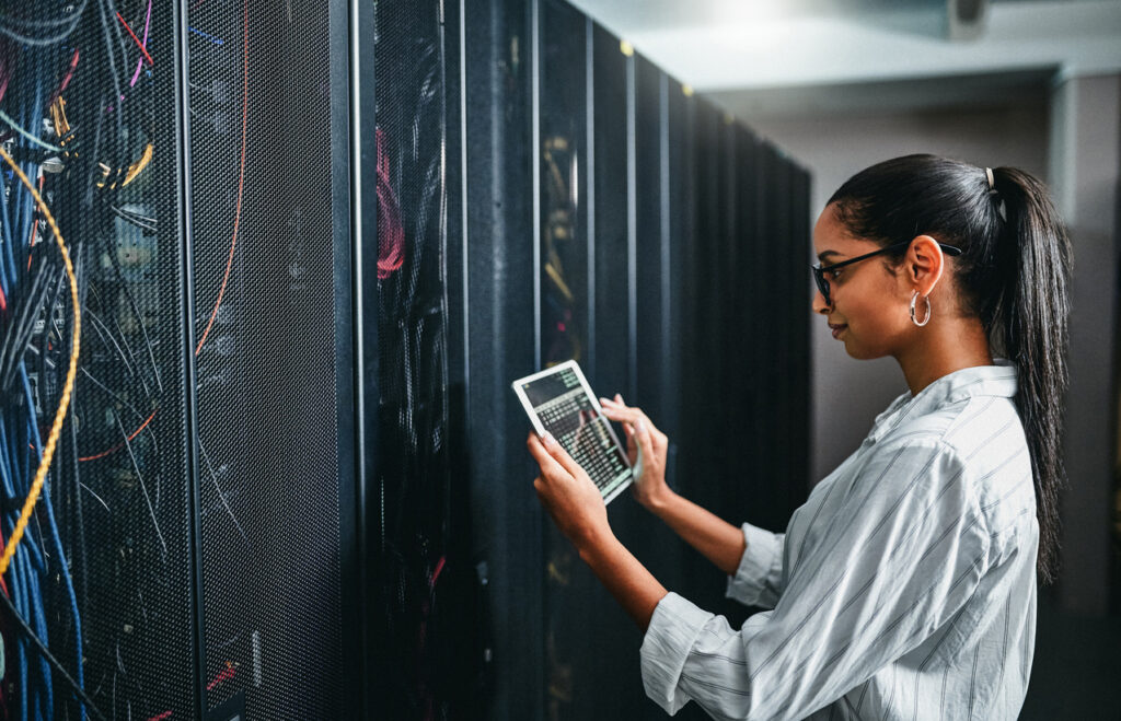 Young woman using a digital tablet while working in cybersecurity