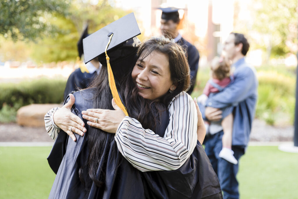 Mother and daughter embrace at college graduation