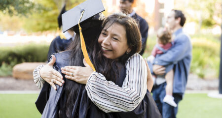 Mother and daughter embrace at college graduation