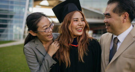 Proud parents with a graduated daughter, ascent lowers APRs