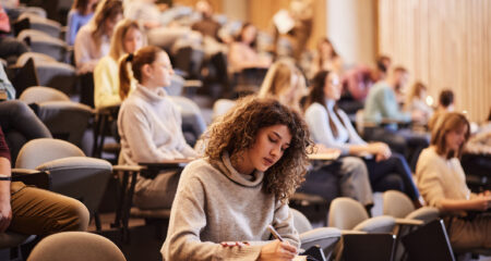 Student in college researching What Does the End of Grad PLUS Loans Mean for Higher Education?