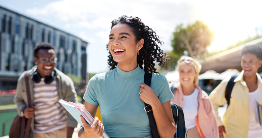 Happy student who learned scholarships can pay for more than just tuition. Learn how scholarship money can be used for books, housing, meals, fees, and other common college expenses.
