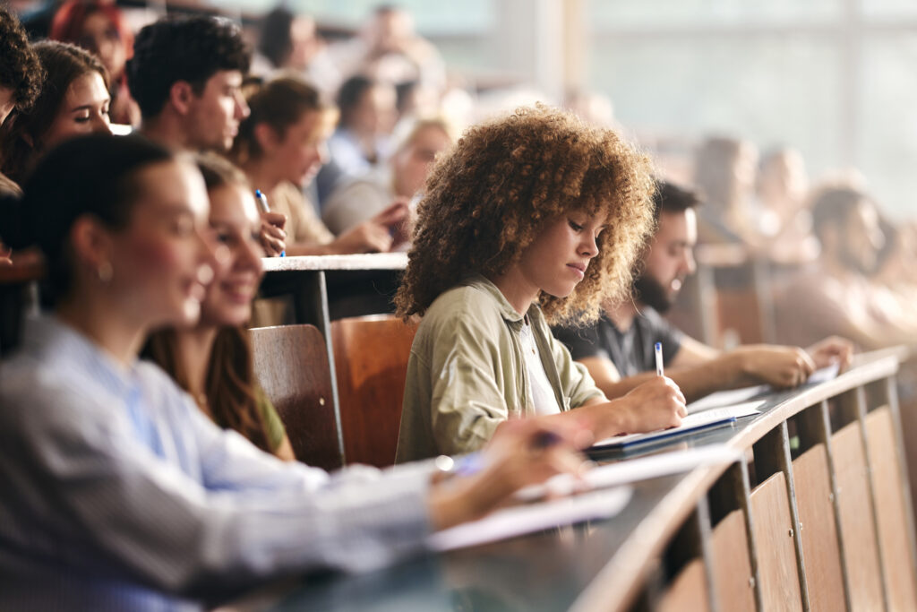 grad student in class estimating the true cost of graduate school after federal loan limit changes. Compare tuition, financial aid, and their funding gap with our grad school cost calculator.