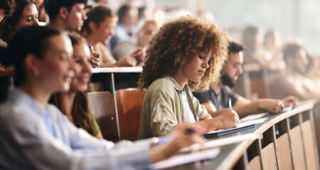 grad student in class estimating the true cost of graduate school after federal loan limit changes. Compare tuition, financial aid, and their funding gap with our grad school cost calculator.