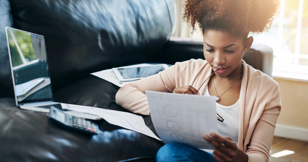 student looking at paper with loan school certification