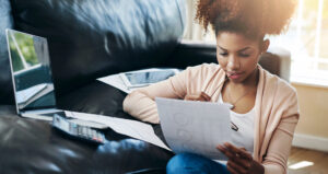 student looking at paper with loan school certification