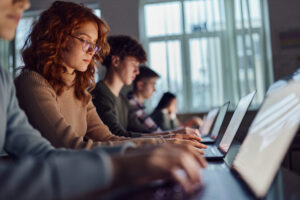 grad student on computer researching financing grad school